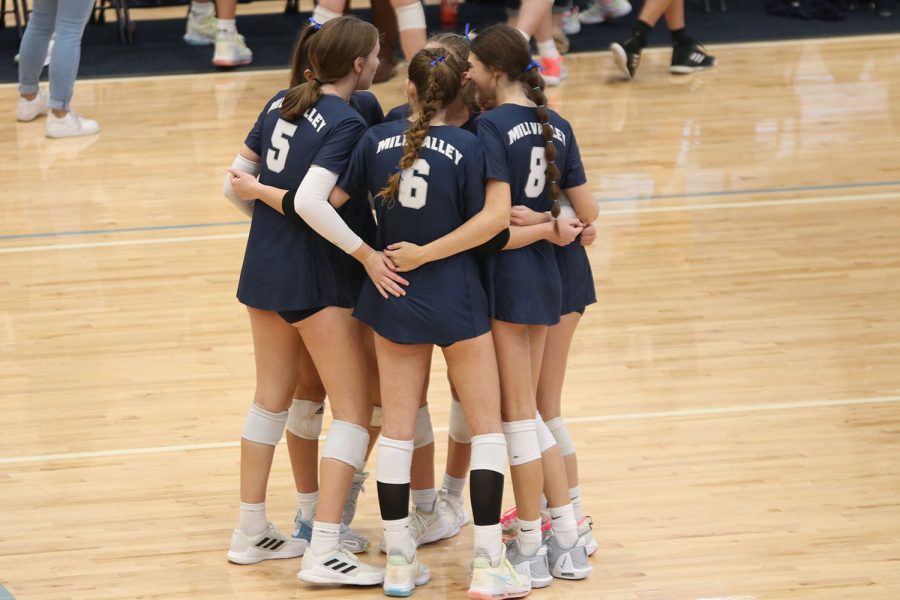 Huddled together, the team celebrates winning the point. 