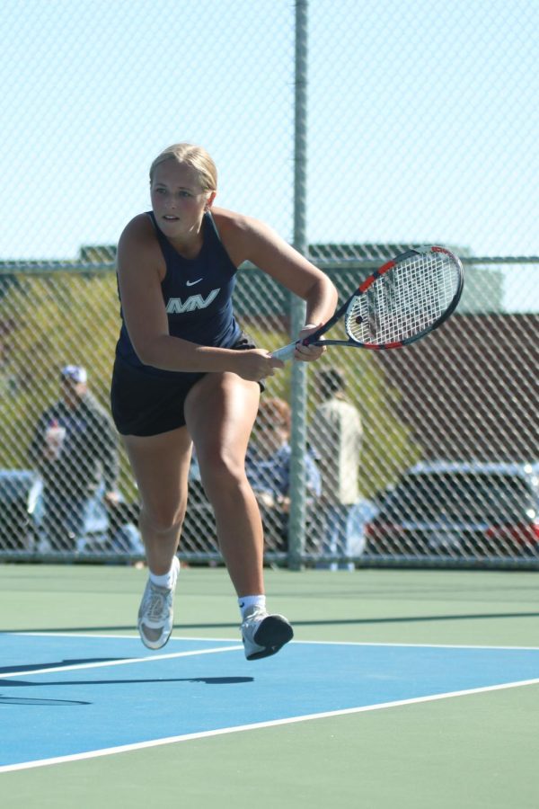Securing her spot at state, senior Avery Blubaugh rushes to the ball.