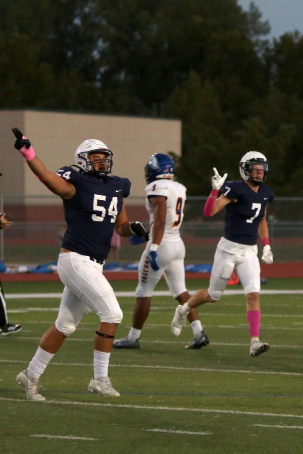 Seniors Spencer Vaka and Mikey Bergeron run back to the sideline after a play.