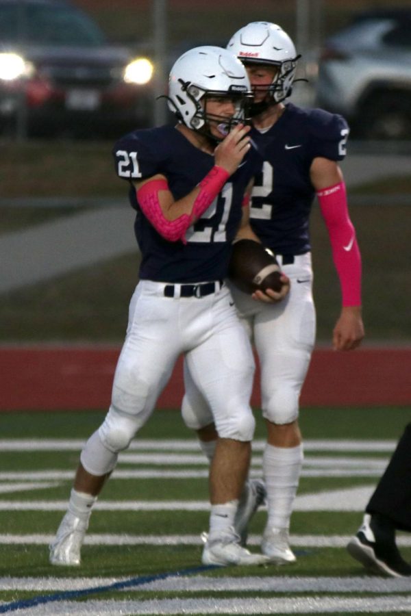 After scoring a touchdown, senior Hayden Jay cheers on his teammate, junior Tristan Baker.