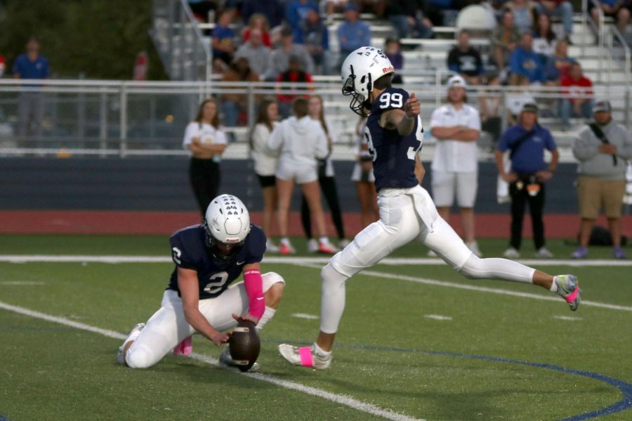 After scoring a touchdown, junior Kenton Laughman kicks for the field goal.
