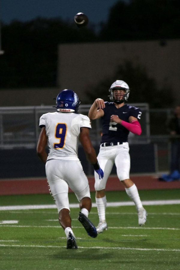 Senior quarterback Hayden Jay throws the ball over the opposing team to another teammate.