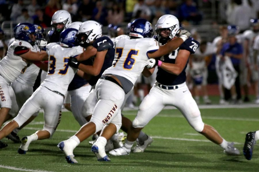 Junior Gus Hawkins grabs a hold of his opponent with hopes to take them down.