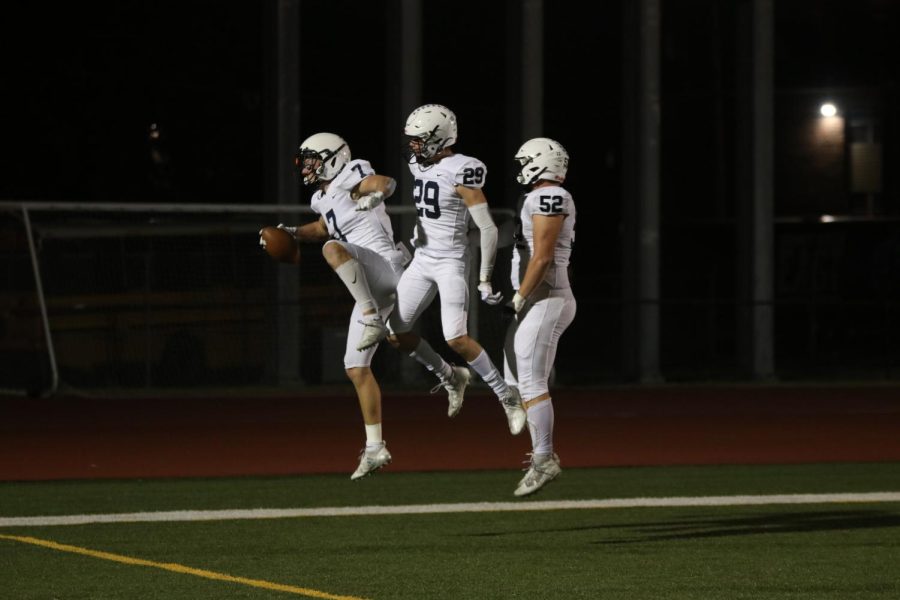 After recovering a fumble from the other team, seniors Mikey Bergeron, Dylan Massey and Grant Rutkowski jump in the air after scoring a touchdown.