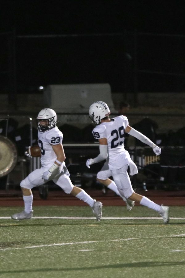 Running into the end zone, senior Holden Zigmant scoring a touchdown.