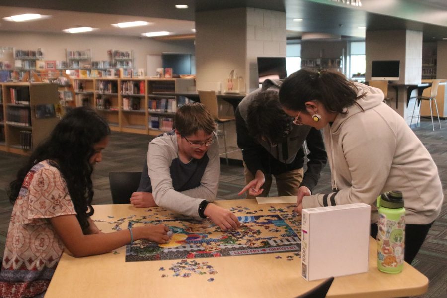 To pass time during their bye round, the quiz bowl team works on a puzzle.