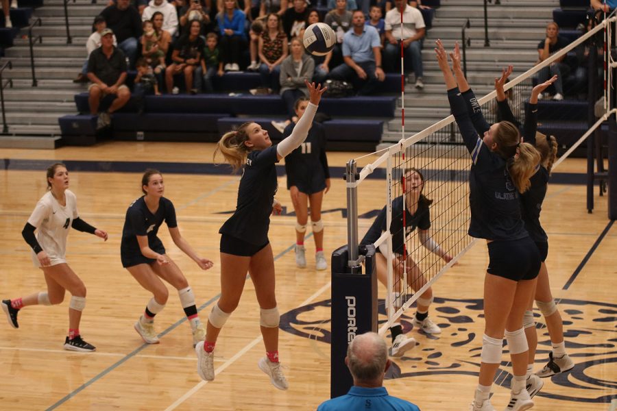 Soaring through the air, senior Madeline Schnepf hits the ball over the net to secure a point for the Jaguars.