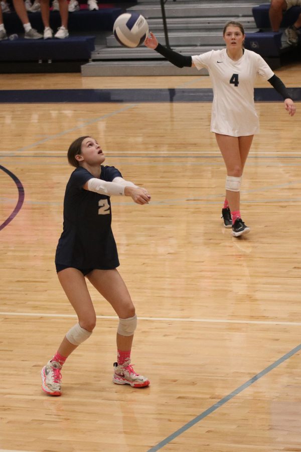Eyes on the ball, junior Ava Jones readies her arms to make a perfect pass.