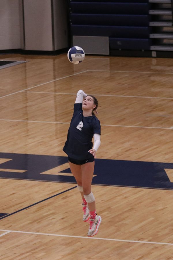 Junior Ava Jones gets in position to serve the ball to the opponents.