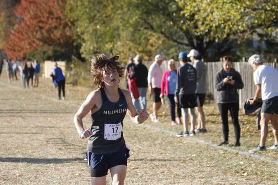 Looking towards the finish line, sophomore Thomas Helm finishes the race. 