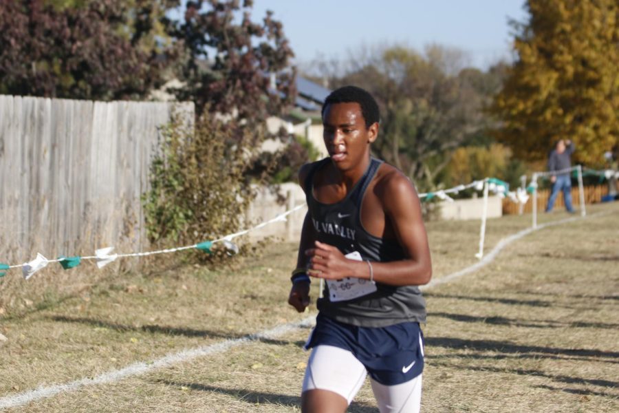 Running around the curve, junior AJ Vega finishes the race. 