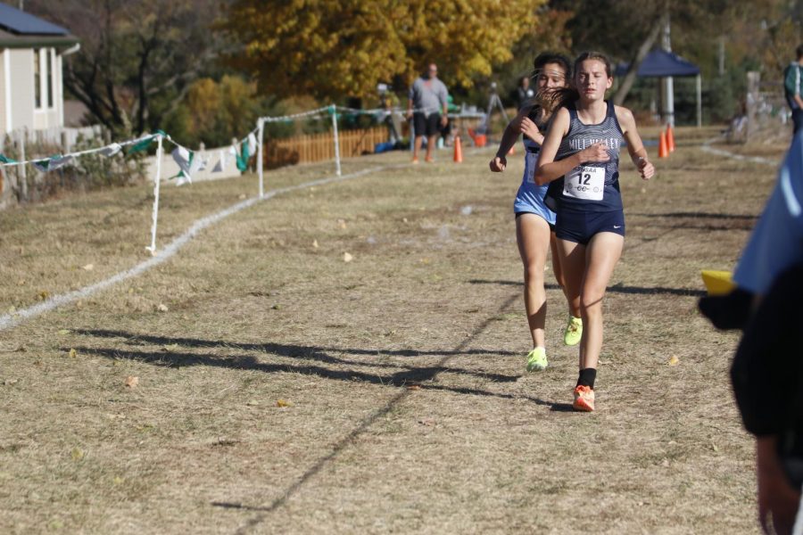 Keeping her mind set on the race, sophomore Meg McAfee runs steadily. 