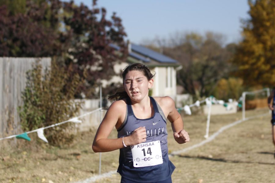 Nearing the finish line, junior Kynley Verdict pushes herself to finish the race. 