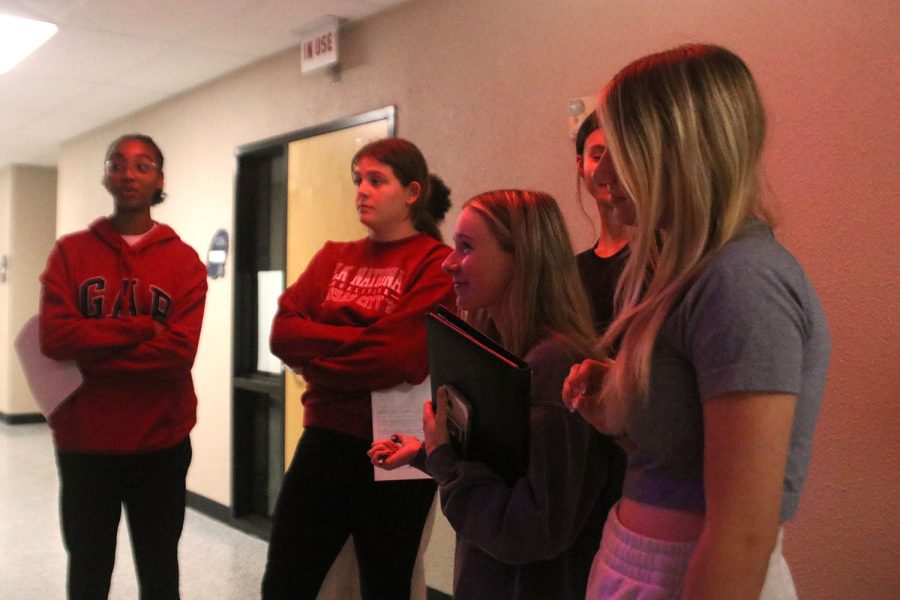 Under the eerie red lights of Mrs. Lloyd’s classroom, door decorating senior judges Chloe Miller, Baylen Monson, and Natalie Merley and freshmen Leilah Perry and Josephine Crossley give the door a high score Thursday Oct. 27.