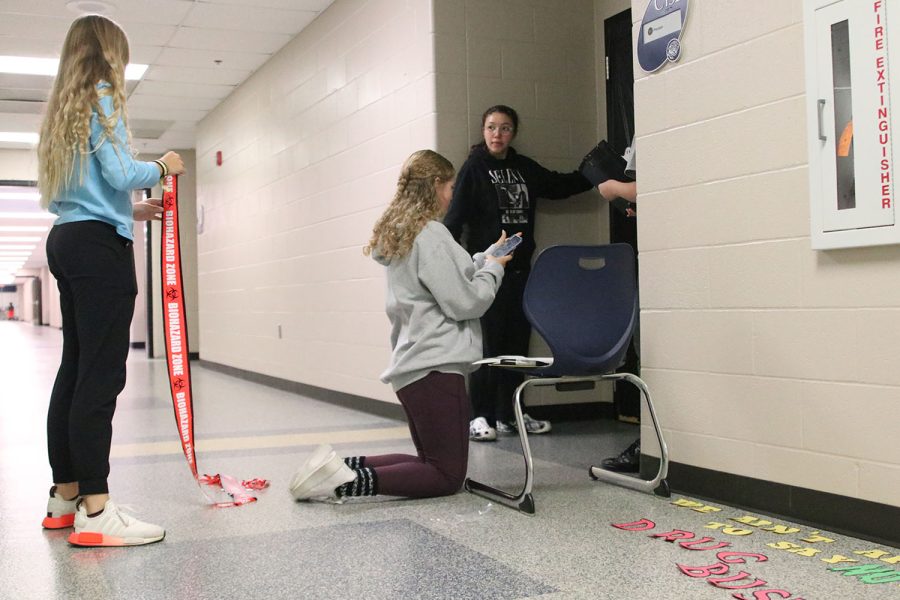 Freshmen Eva Hernandez, Ian Hernandez, Alexa Hocker, and Abby Haney divide and conquer to finalize their design for the door decorating competition.