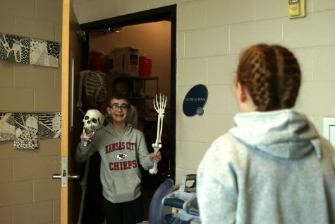 As he searches for unique door decorations in the art department storage room, freshman Ryan Cannata finds the perfect items for Mrs. Matyaks door Wednesday Oct. 26.