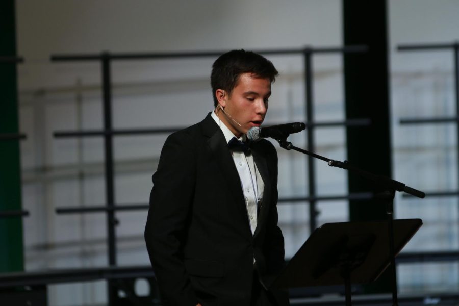 Before the choir sings, junior AJ Lauer explains why they chose the song. 