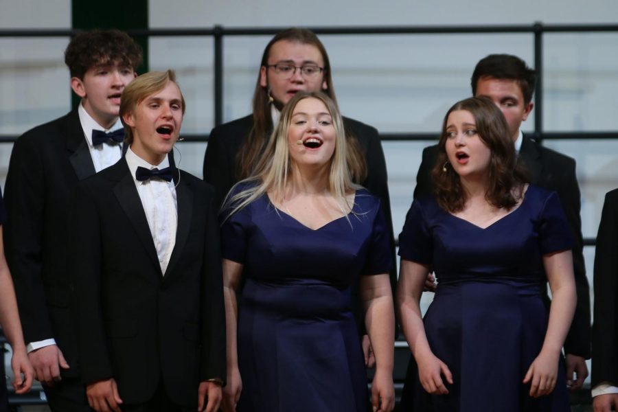 Along with the rest of the Jag Singers choir, senior Carter Harvey and juniors McKinley Graves and Sarah Coleman sing with a smile. 