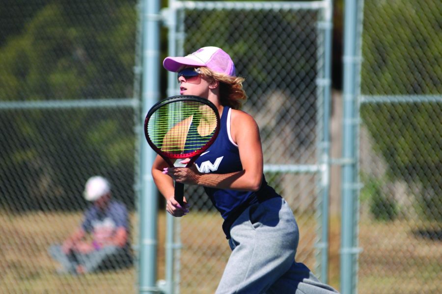 Increasing her speed, freshman Heidi Baillos sprints to return a difficult ball. 