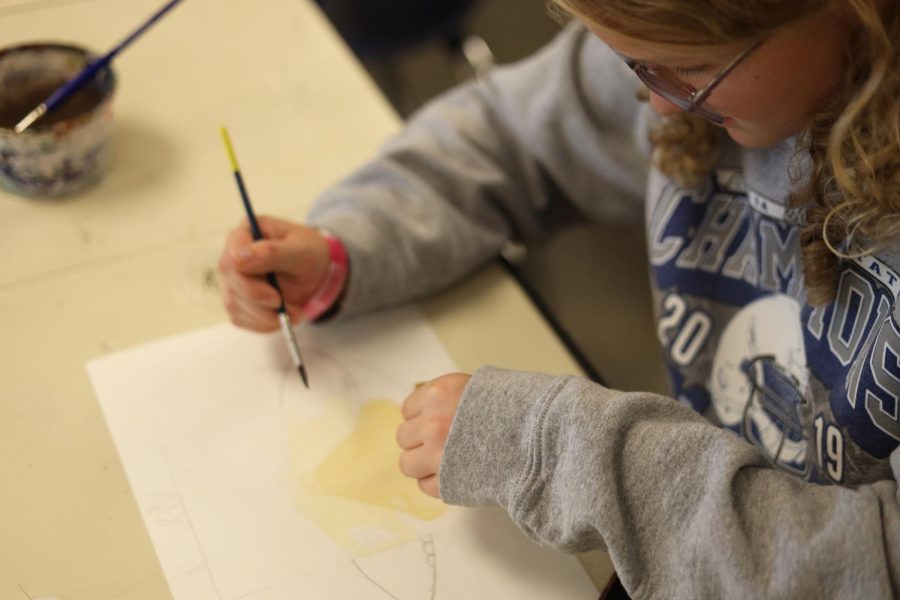 Freshman Melia Davis adds yellow water color to her painting Sept. 16 in Krystal Strong’s Art I class.