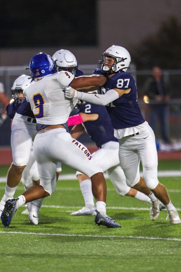 Fighting the defensive line, senior Will Smoots holds his opponent back.
