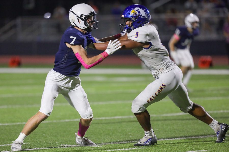 Trying to get around the opponent, senior Mikey Bergeron pushes against the player. 