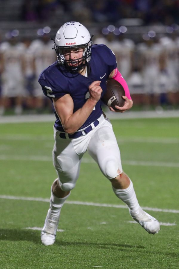 After realizing none of his teammates were open, senior quarterback Hayden Jay runs down the field with the ball in his hands.