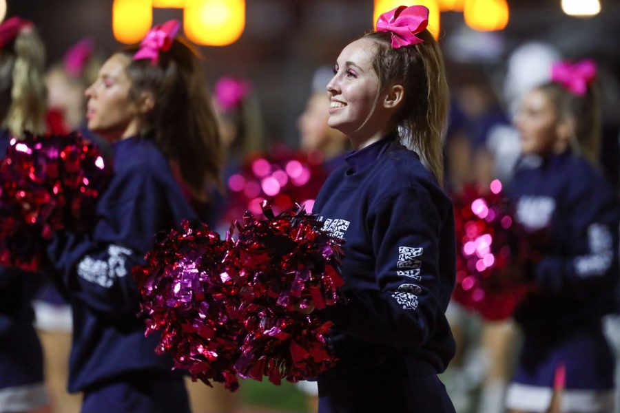 With a smile on her face, senior Kate Kline looks into the crowd during the cheer. 