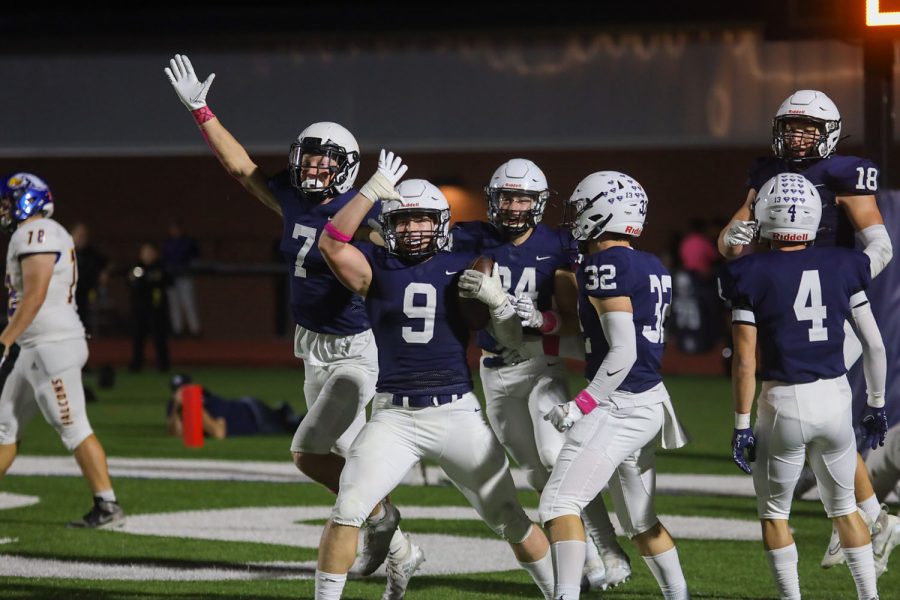 Senior Noah Coy holds his fin up alongside his teammates celebrating their recovery. 