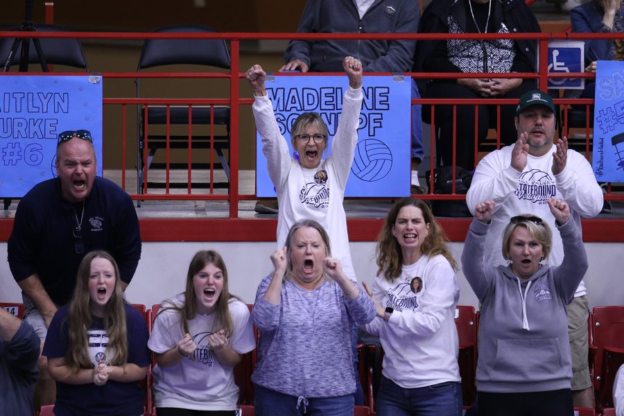 After a kill on the court, parents of the players celebrate from the stands during the match against Free State.