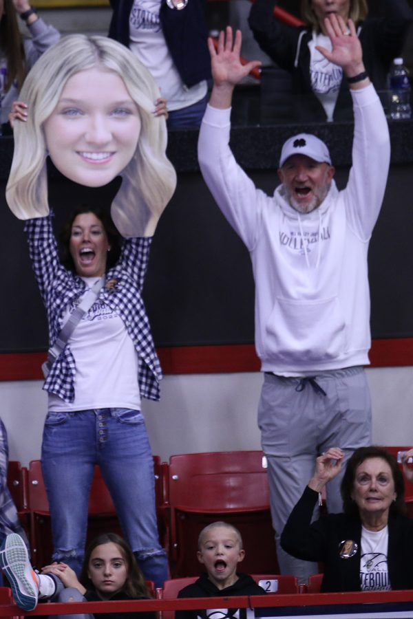 The parents of senior Madeline Schnepf, show off a fat-head of their daughter during the state match against Free State. The Jags beat the Firebirds 2-0. 