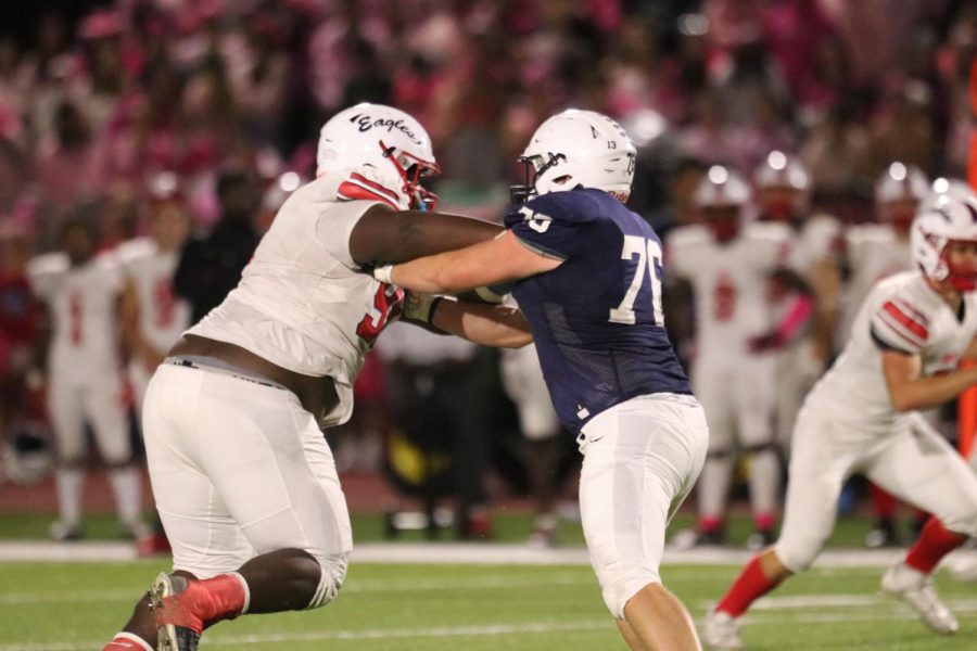 Senior Jack Melvin pushes against an Olathe North lineman. 