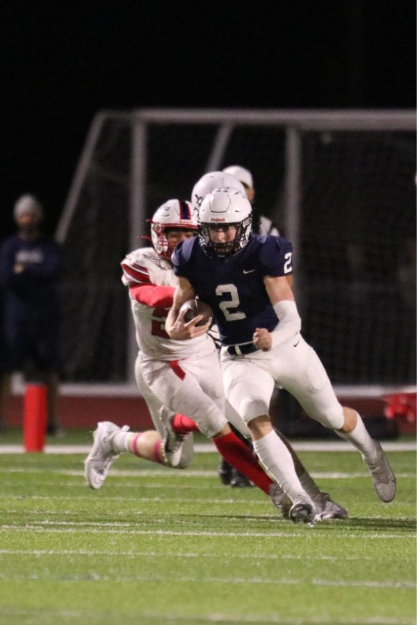 Ball in hand, senior Hayden Jay attempts to gain yardage on the drive.