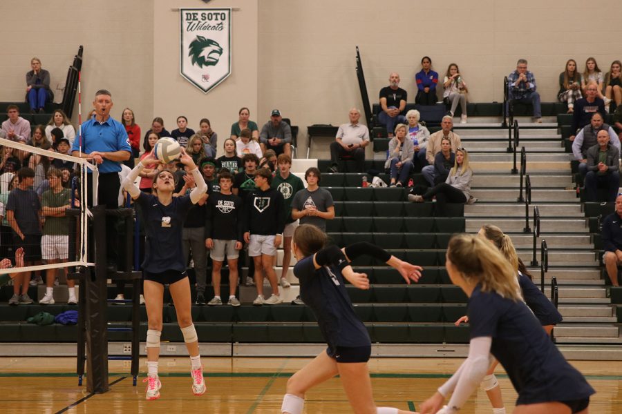 Focusing on the ball, junior Ava Jones sets up her teammate for a hit. 
