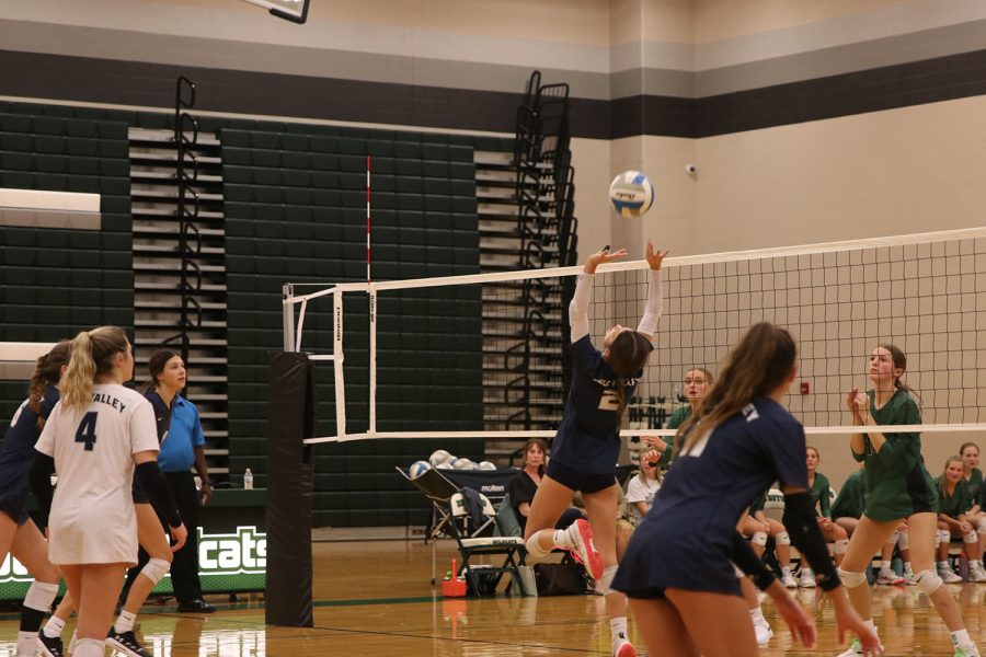 Diving backwards, junior Ava Jones sets the ball to her teammate. 
