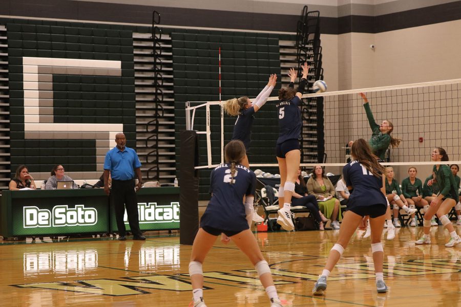 Moving together, sophomore Saida Jacobs and senior Madeline Schnepf jump to block the opponents hit. 
