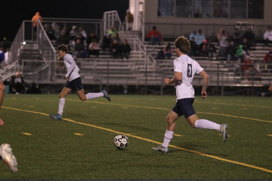 Senior Nico Pendleton dribbles down the field.