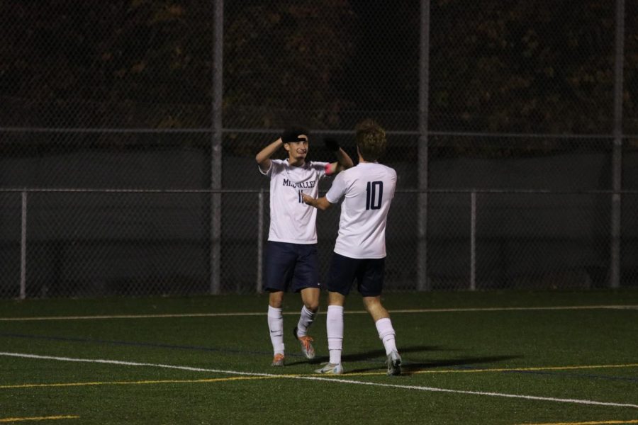 Seniors Dylan Ashford and Nico Pendleton congratulate each other after scoring a goal.
