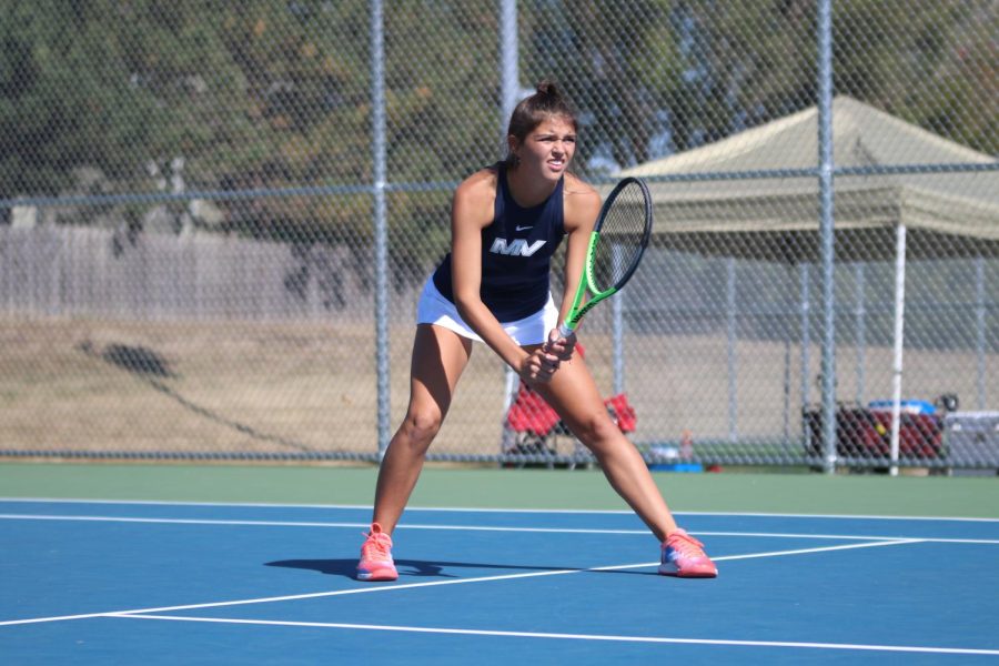 In her stance, junior Emily Stove waits to hit the ball.