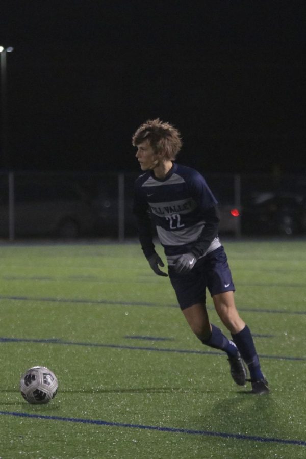 Looking down the side of the field, sophomore Brady Robins looks to pass the ball.