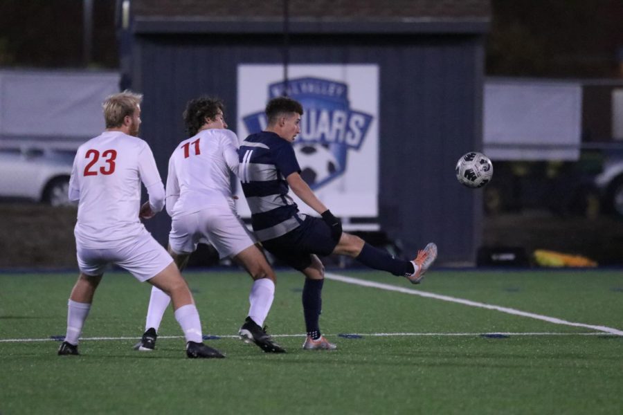 With pressure from his opponent on his back, Senior Dylan Ashford receives the ball in order to make a pass. 