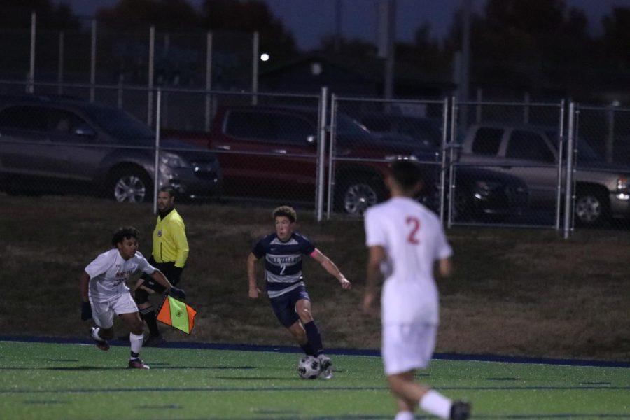 On the SMNs side of the field, senior Luke Shideler dribbles the ball towards the goal. 