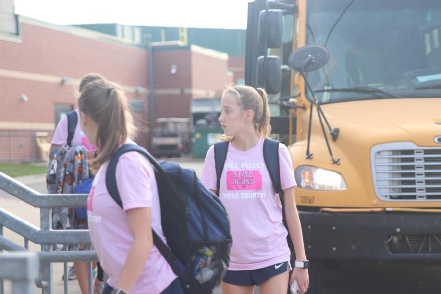 Sophomore Callie Cahoy makes her way up the stairs after arriving back to school from the 6A cross country state meet.