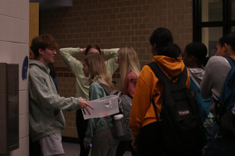 Standing at the entrance to the PAC, senior Sonny Pentola collects tickets for the annual Video Productions Film Festival hosted by VidPro students.