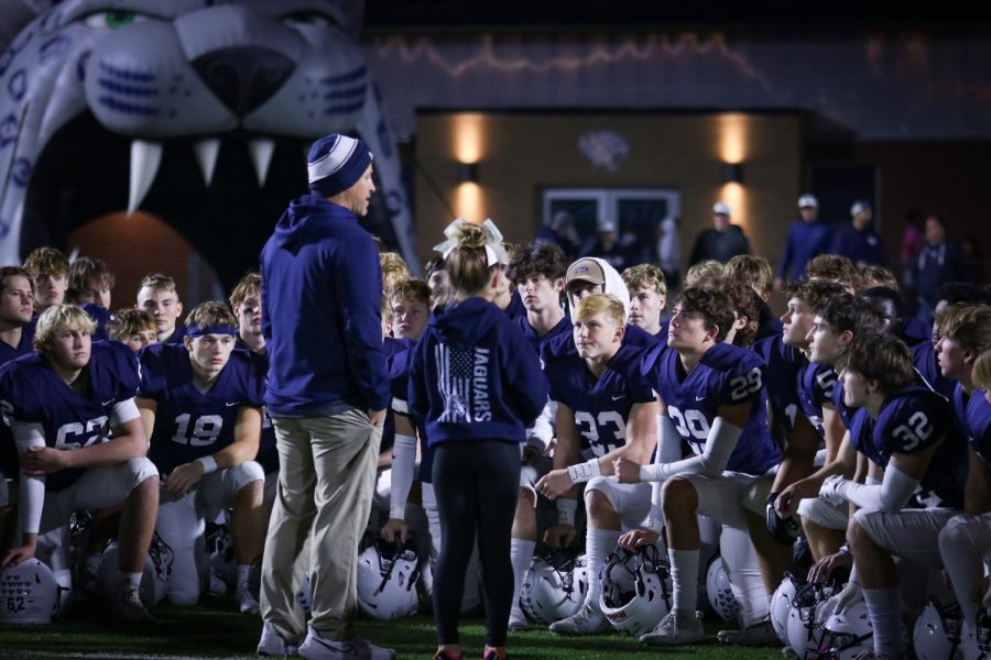 Gathered at center field after the game, head coach Joel Applebee addresses the football team for their post-game huddle.