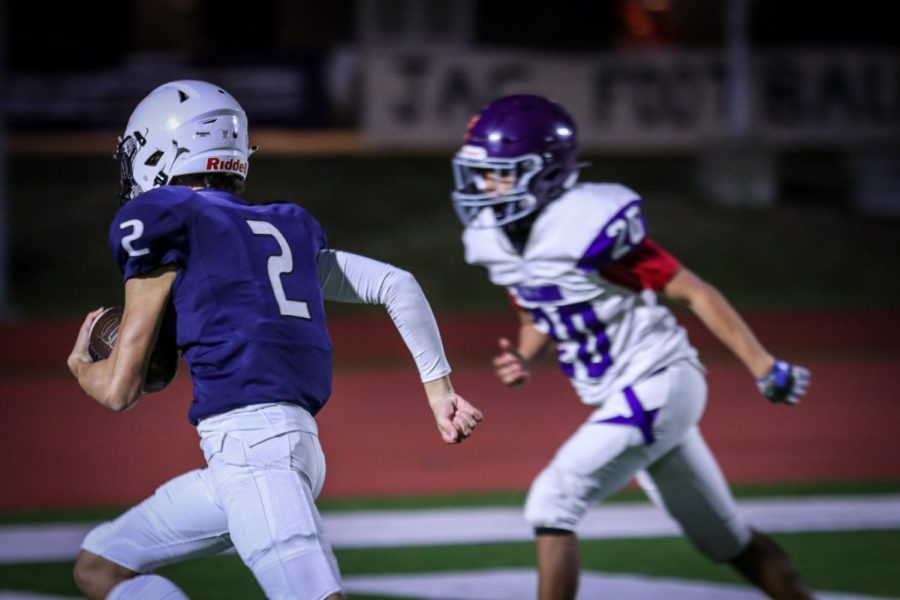 Running past a J.C. Harmon defensive player, freshman Blake Jay runs for a touchdown.