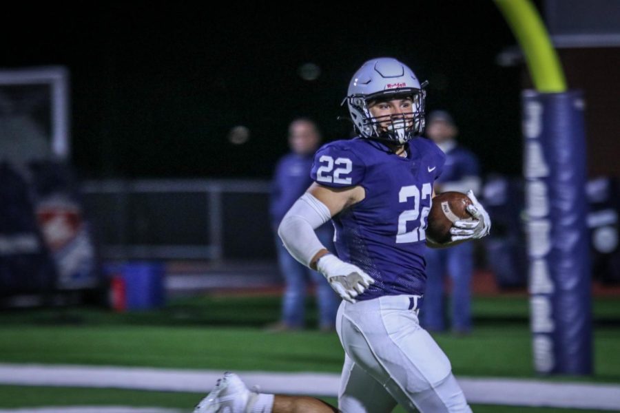 Running into the endzone, junior Evan Seifert completes a touchdown. 