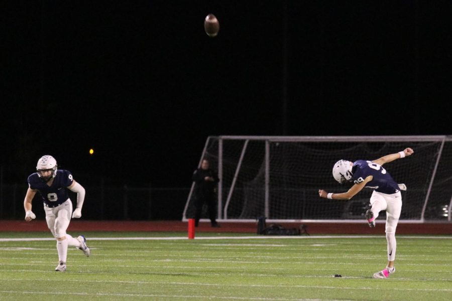 At kickoff, junior Kenten Laughman kicks the ball.