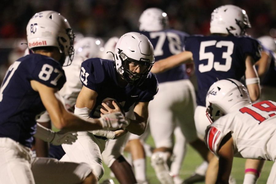 Junior Tristan Baker runs around the opposing team. 