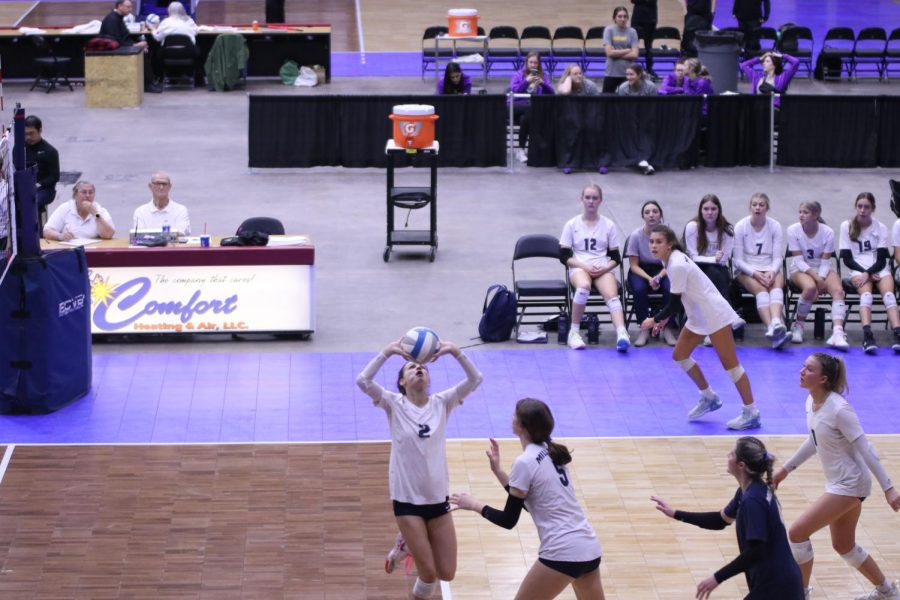 With her hands above her head, junior Ava Jones sets the ball for her teammate.